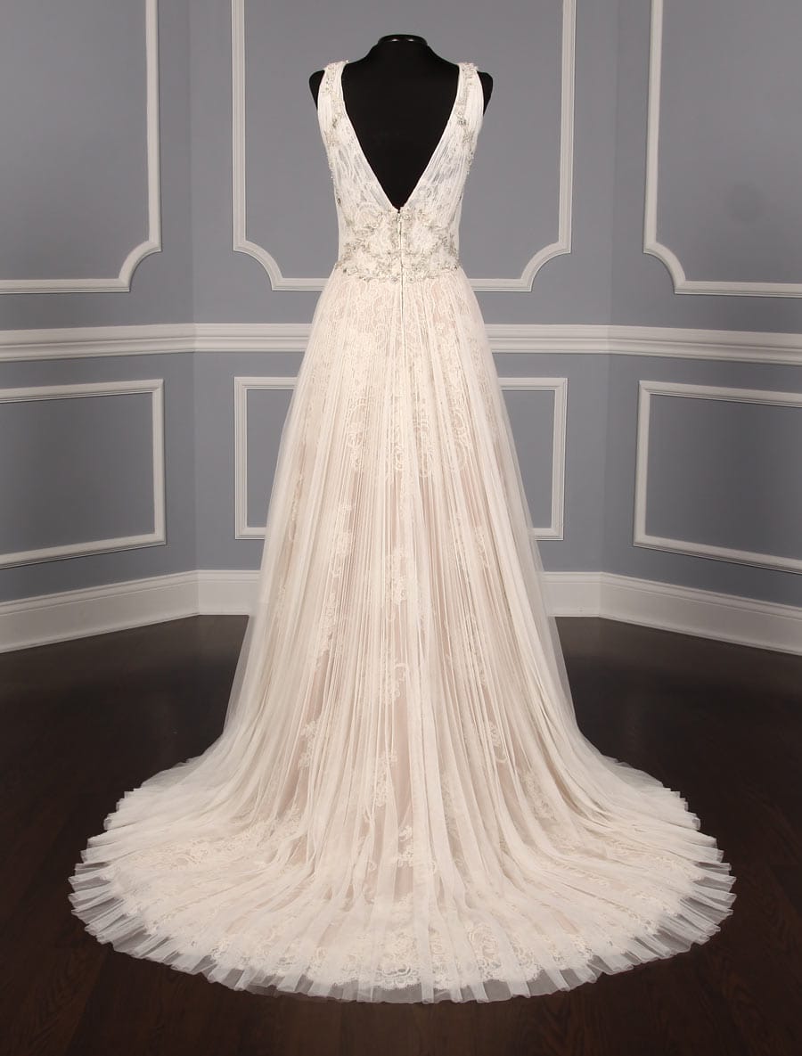 This gorgeous Isabelle Armstrong Willow wedding dress is Brand New!  This wedding gown is truly a work of art!!  You will be in awe when you see how incredible this gown is in person.  It is made from luxurious French Alencon Lace with an overlay of English Net and beading on the bodice.  The outer fabrics are silk white (diamond white) and the lining is a nude color.  The sleeveless v-neck and v-back bodices flow into an a-line silhouette with a chapel train.
