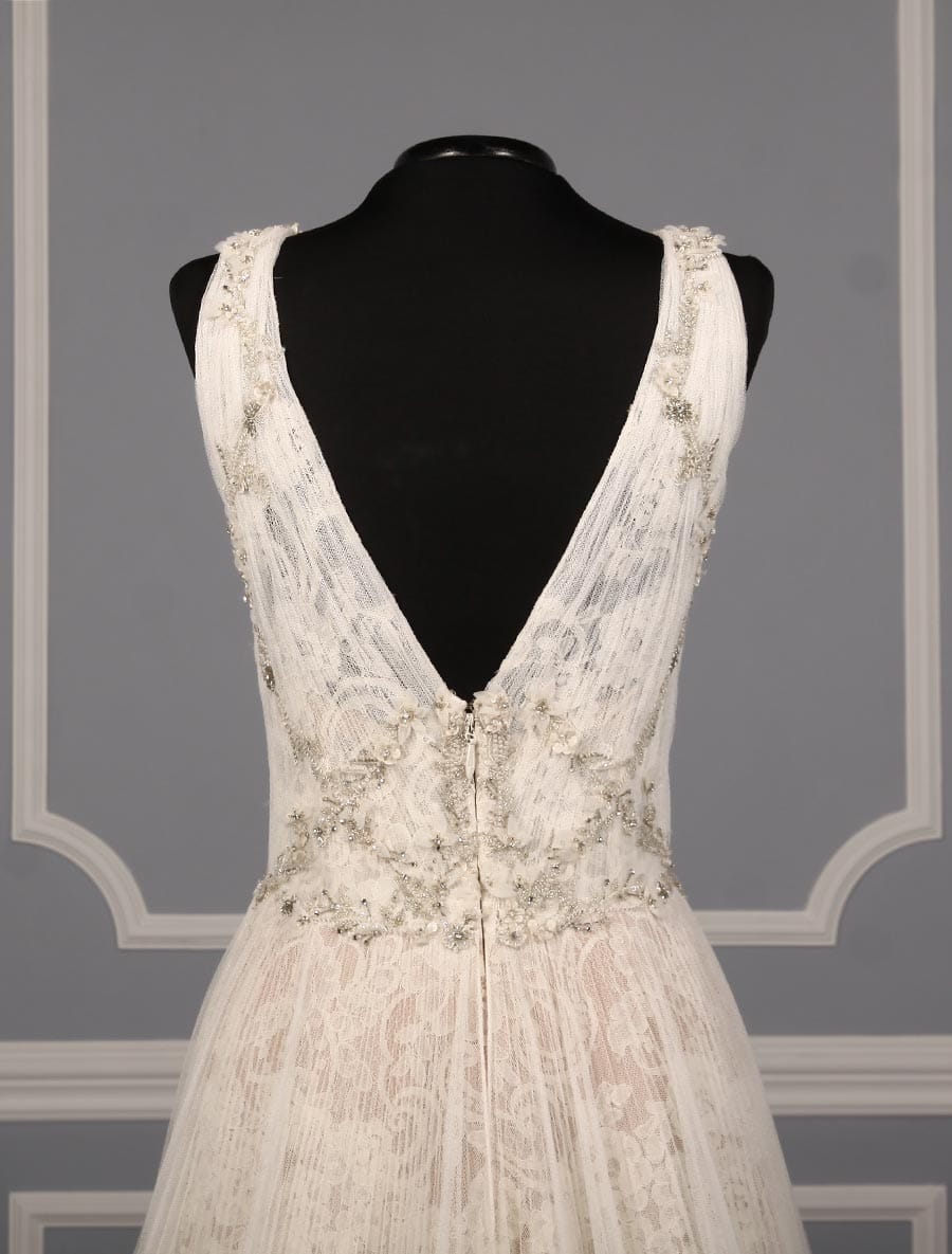 This gorgeous Isabelle Armstrong Willow wedding dress is Brand New!  This wedding gown is truly a work of art!!  You will be in awe when you see how incredible this gown is in person.  It is made from luxurious French Alencon Lace with an overlay of English Net and beading on the bodice.  The outer fabrics are silk white (diamond white) and the lining is a nude color.  The sleeveless v-neck and v-back bodices flow into an a-line silhouette with a chapel train.