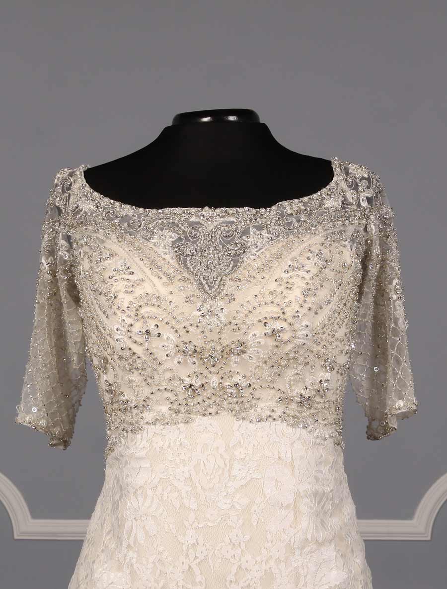 This Allure C341 wedding dress is Brand New and has its hang tag attached!  The workmanship on this gown is amazing in person!  The beading and embroidery on the bodice are out of this world!  Luxurious lace creates the fit and flare design of this Allure wedding gown.  The light gold lining shows through giving the gown a soft touch of color.  There are sheer short sleeves, a sheer back, an empire waist and a trumpet silhouette that flows into a chapel train.