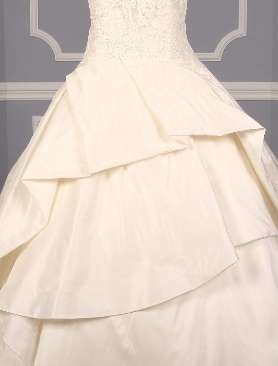 This Kenneth Pool Ina K514 wedding dress is in excellent, ready to wear condition!  The ivory French Alencon lace and silk taffeta fabrics are gorgeous in person.  The sleeveless wedding gown has a sheer bodice, v-back, dropped waist and a ballgown silhouette.  What a wonderful, comfortable gown to dance the night away!