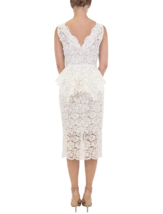 This beautiful Nha Khanh Hana wedding dress is Brand New!  It is made from gorgeous ivory lace with a nude color lining.  This tea length dress is sleeveless with a bateau neckline, a v-back and a sheath silhouette.  A hand trimmed lace peplum is just below the waist.  You could wear this lace dress for your bridal shower, rehearsal dinner, reception, destination wedding, courthouse wedding or any type of wedding venue!  An easy dress to pack for traveling.  It is a great cocktail party dress also.