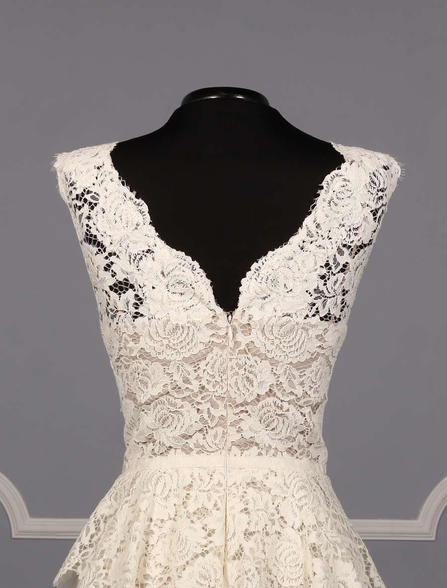 This beautiful Nha Khanh Hana wedding dress is Brand New!  It is made from gorgeous ivory lace with a nude color lining.  This tea length dress is sleeveless with a bateau neckline, a v-back and a sheath silhouette.  A hand trimmed lace peplum is just below the waist.  You could wear this lace dress for your bridal shower, rehearsal dinner, reception, destination wedding, courthouse wedding or any type of wedding venue!  An easy dress to pack for traveling.  It is a great cocktail party dress also.