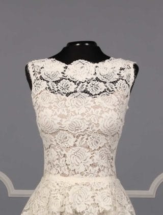 This beautiful Nha Khanh Hana wedding dress is Brand New!  It is made from gorgeous ivory lace with a nude color lining.  This tea length dress is sleeveless with a bateau neckline, a v-back and a sheath silhouette.  A hand trimmed lace peplum is just below the waist.  You could wear this lace dress for your bridal shower, rehearsal dinner, reception, destination wedding, courthouse wedding or any type of wedding venue!  An easy dress to pack for traveling.  It is a great cocktail party dress also.