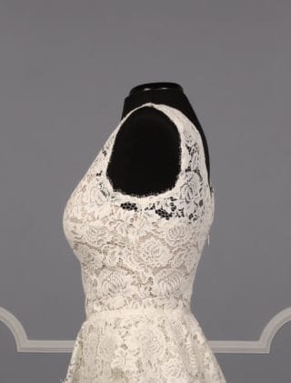 This beautiful Nha Khanh Hana wedding dress is Brand New!  It is made from gorgeous ivory lace with a nude color lining.  This tea length dress is sleeveless with a bateau neckline, a v-back and a sheath silhouette.  A hand trimmed lace peplum is just below the waist.  You could wear this lace dress for your bridal shower, rehearsal dinner, reception, destination wedding, courthouse wedding or any type of wedding venue!  An easy dress to pack for traveling.  It is a great cocktail party dress also.