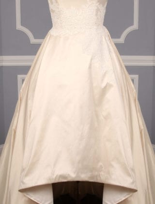 This Romona Keveza Legends L7130 wedding dress is Brand New!  It is made from beautiful silk shantung taffeta with lace appliques.  The ivory color is a vanilla shade, a bit of a warmer ivory.  This Romona Keveza Legends wedding dress is strapless with a ballgown silhouette, a high low hemline and a chapel train.  Side seam pockets are hidden in the skirt and are perfect for holding a few tissues or your lipstick.  You will definitely 'wow' your guests as you walk down the aisle in this stunning couture creation!